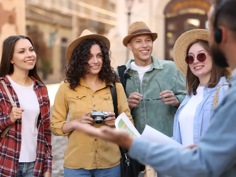 guide-with-headset-and-group-of-tourists-on-city