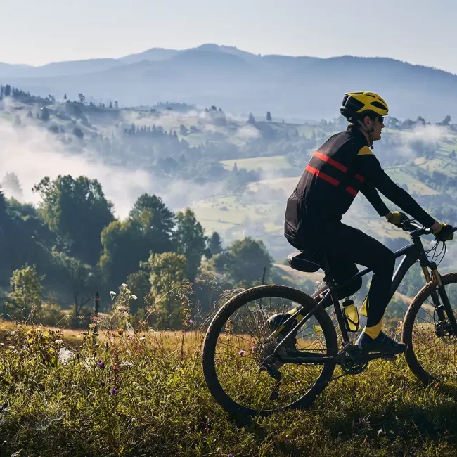 male-cyclist-riding-bicycle-in-mountains