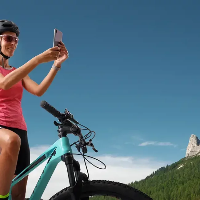 smiling-woman-on-mountain-bike-taking-photo