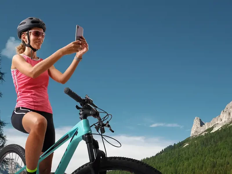 smiling-woman-on-mountain-bike-taking-photo